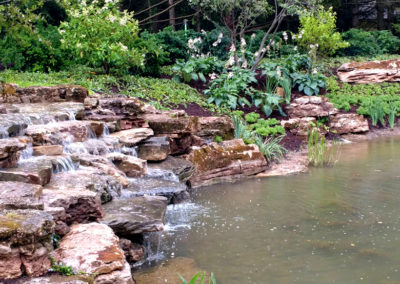 Stone waterfall with landscaped bank and pond - AFTER