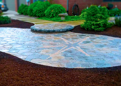 Custom stone paver patio with starburst inlay.
